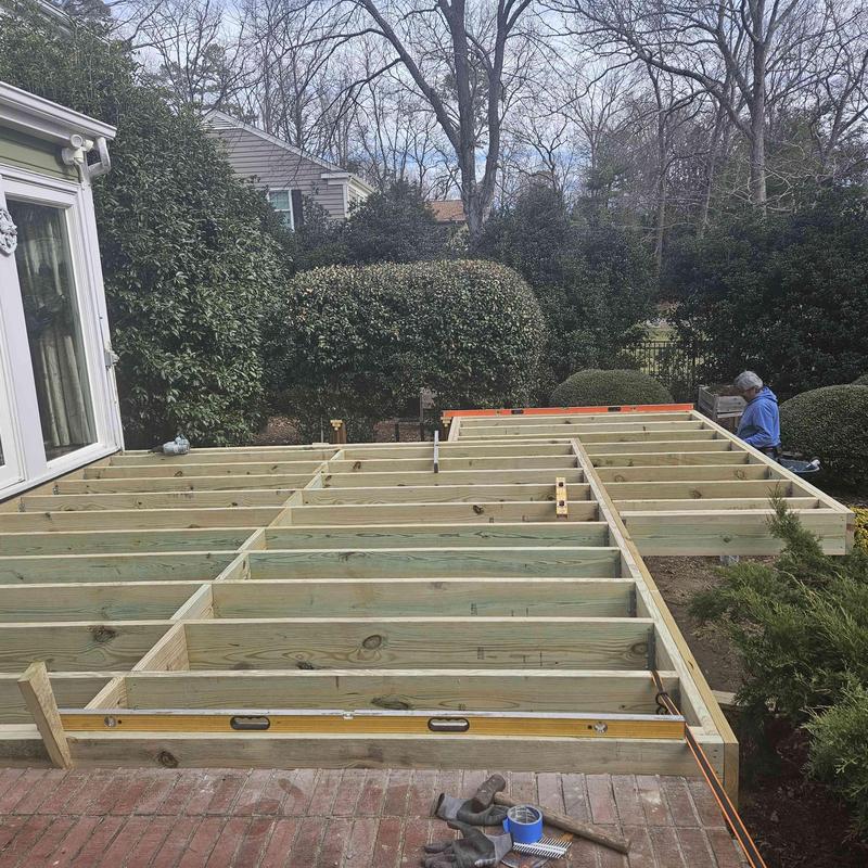Wood deck framing installation with level and tools Wood deck framing installation with level and tools