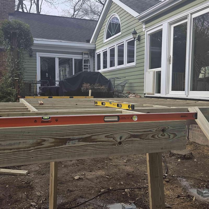 Wood deck framing with levels and tools on site Wood deck framing with levels and tools on site