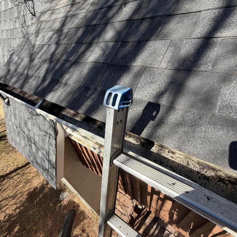 Gutters partially filled with debris before cleaning
