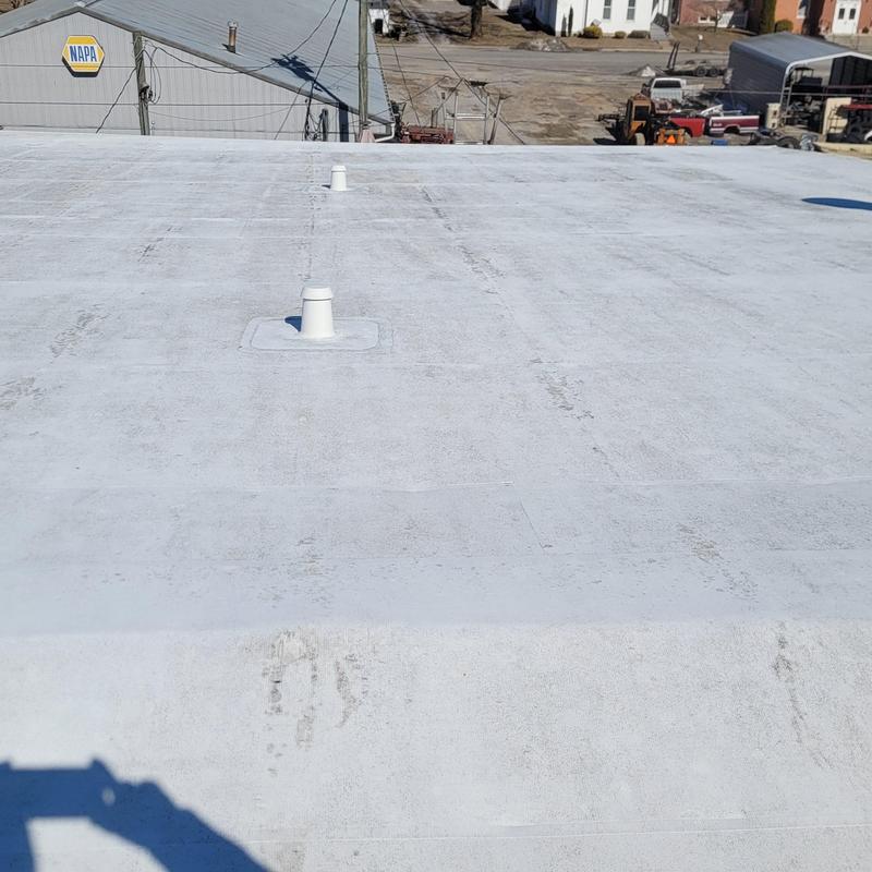 Commercial flat roof with vent pipes and rooftop view