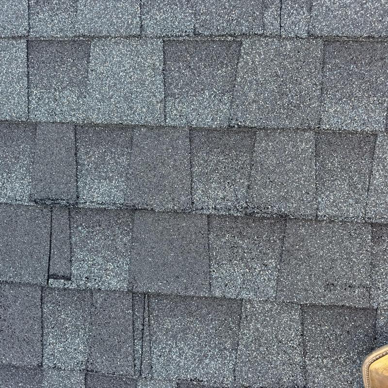 Roof shingles with damage and installation defects Roof shingles with damage and installation defects