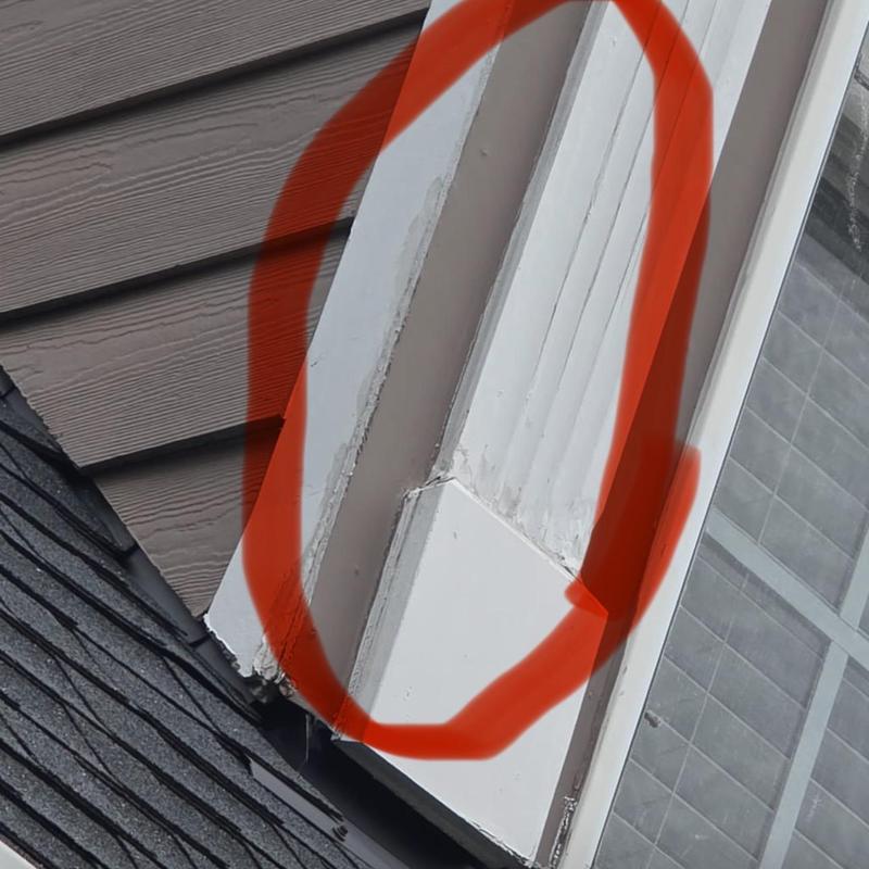 Wood siding corner with rot and flashing repair area