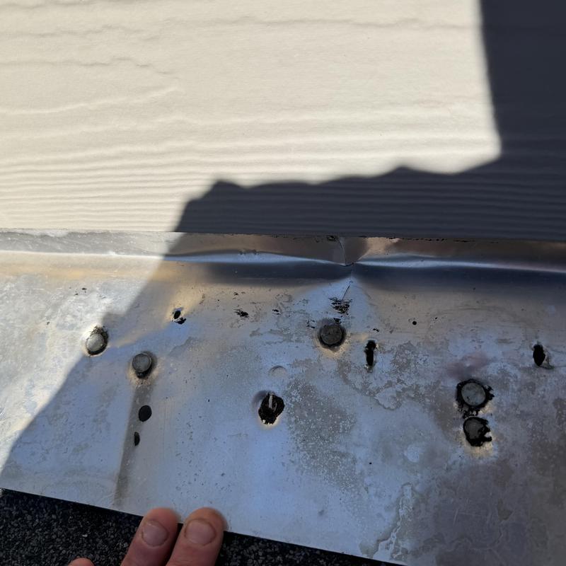 Wall flashing with holes causing roof leak