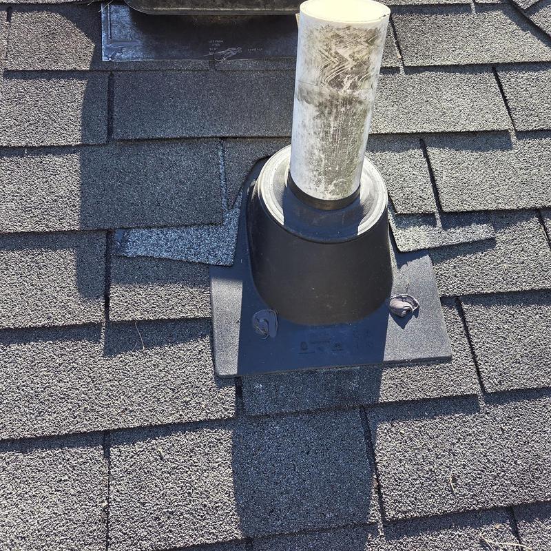 Pipe boot and surrounding shingles on roof