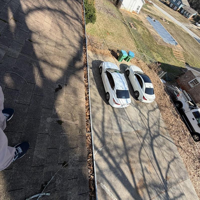 Roof gutters with leaves before cleaning in Loganville GA