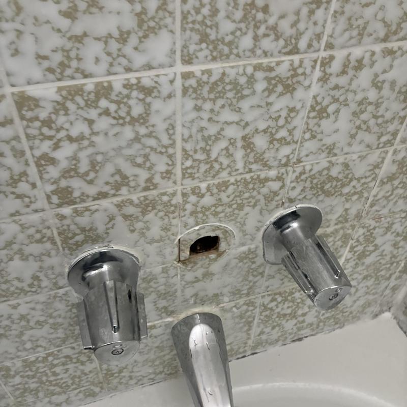 Shower diverter valve removed from tiled wall