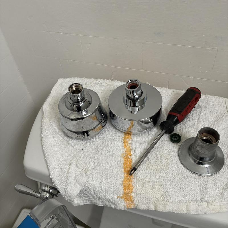 Shower head and diverter parts with screwdriver on towel