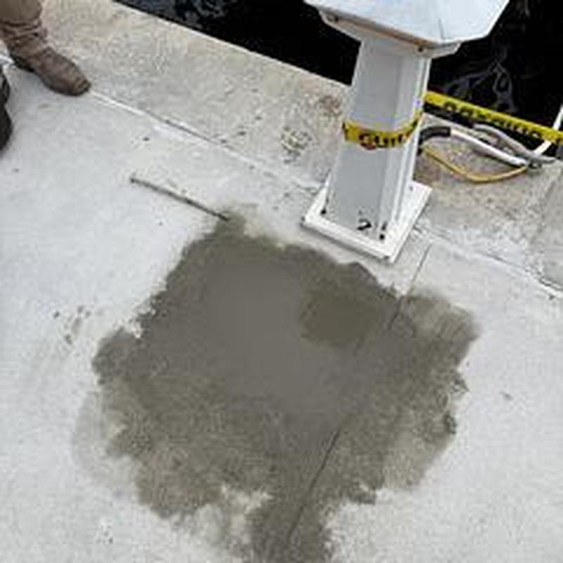 Broken water line patch with concrete near dock pedestal