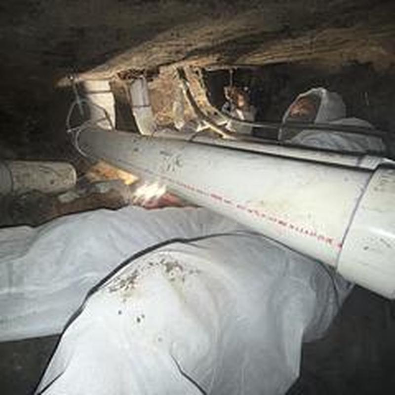 PVC sewer pipe replacement under home with cast iron bends