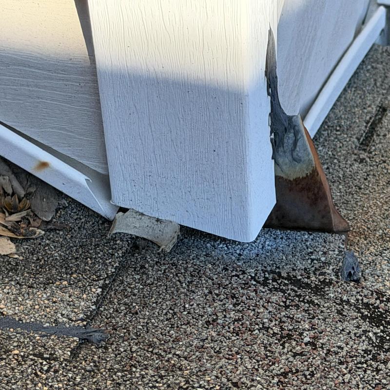 Chimney flashing with rust and deteriorated wood decking