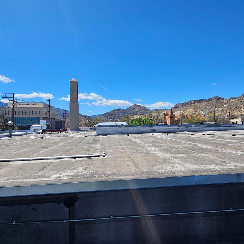 Modified bitumen flat roof inspection with damage visible Modified bitumen flat roof inspection with damage visible