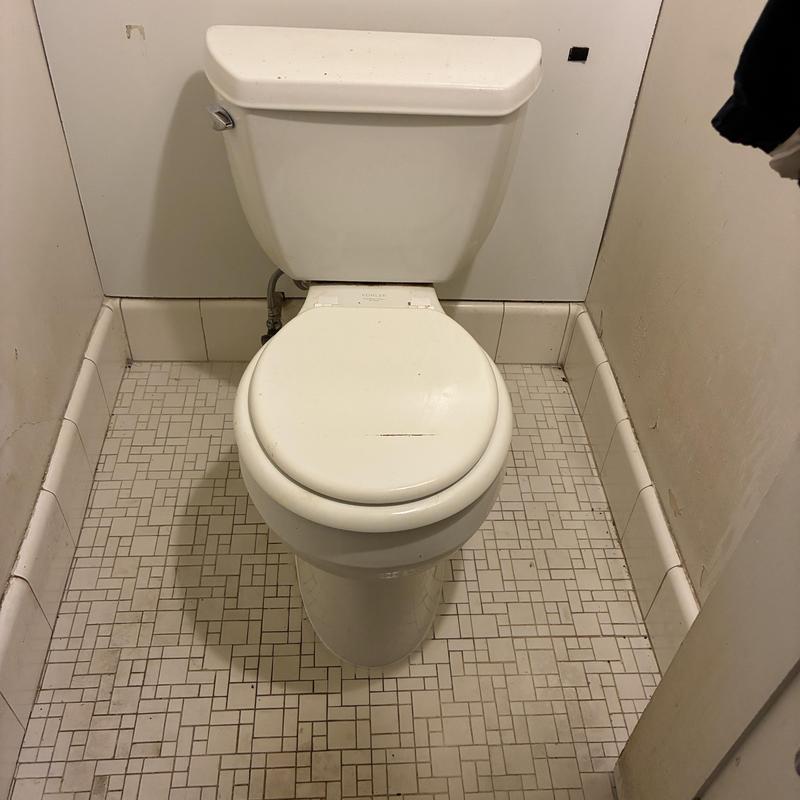 Toilet installation with clean tiled floor edges