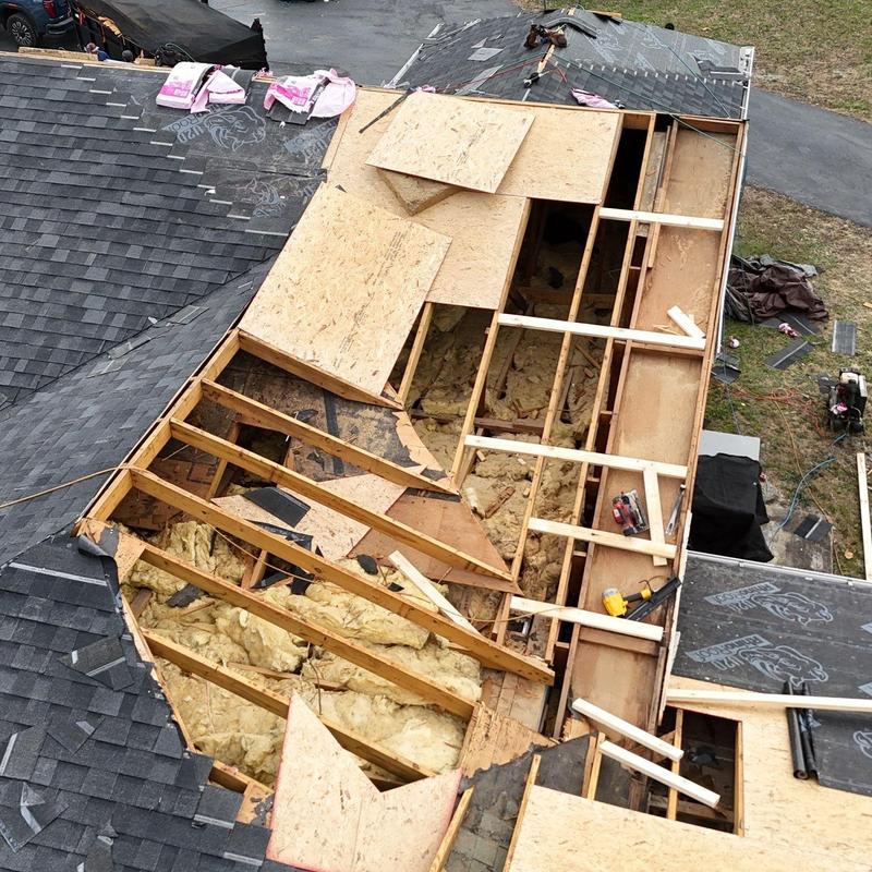Roof decking repair with insulation exposed and shingle removal