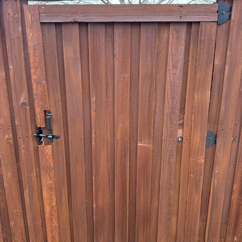 Wooden fence gate with new latch and stain finish