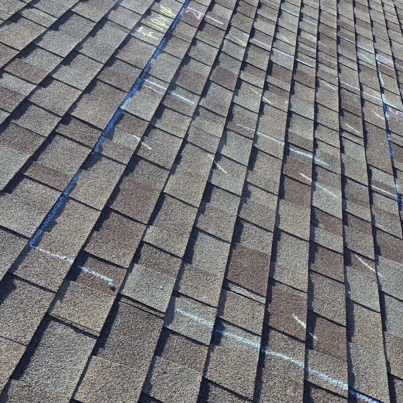 Asphalt shingle roof with hail damage markings