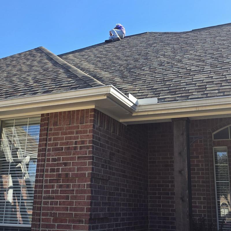 Roof shingles inspection on brick house after hailstorm