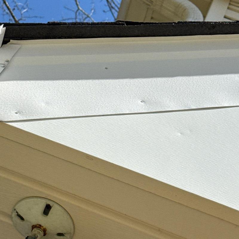 Asphalt shingle roof with hail damage and nail holes