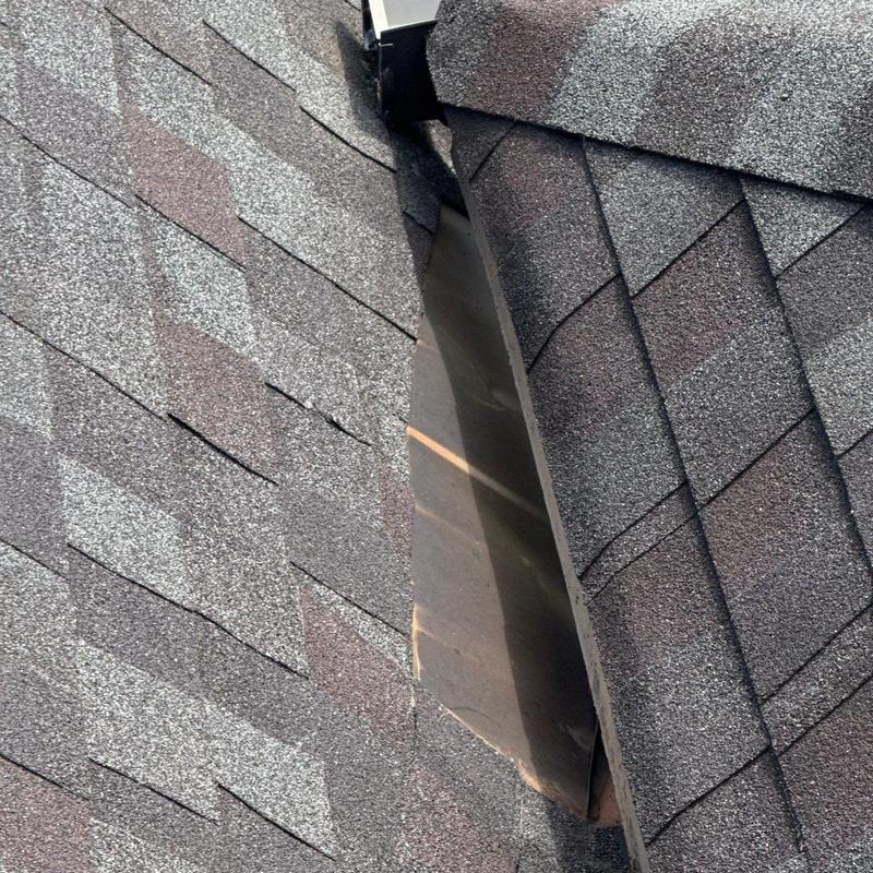 Roof valley flashing with shingle wear and damage