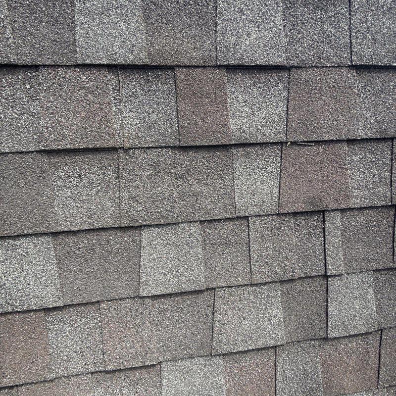 Asphalt shingle roof with hail damage discoloration