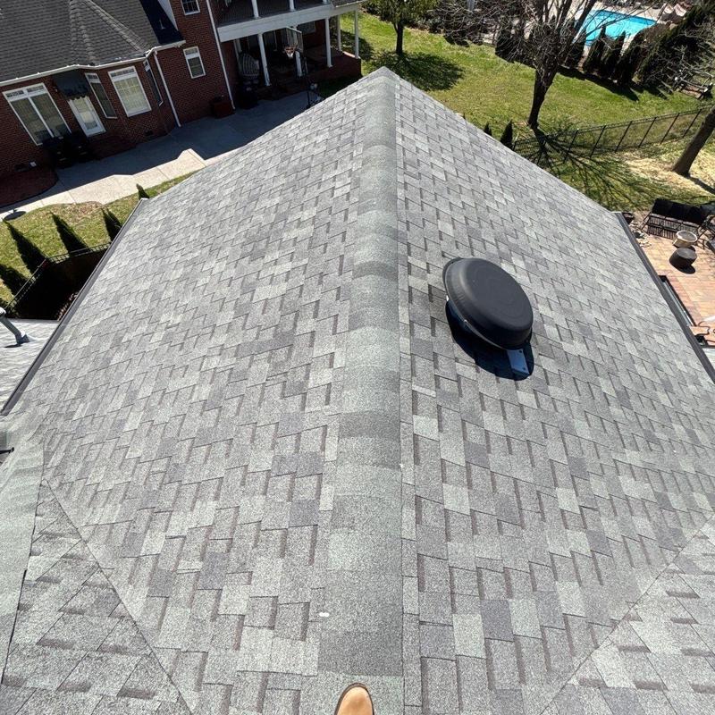 Asphalt shingle roof with ridge vent and roof vent