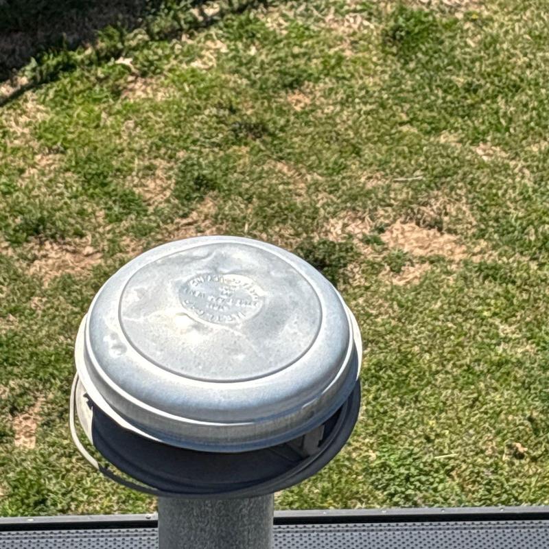 Roof vent cover on grassy ground outdoors