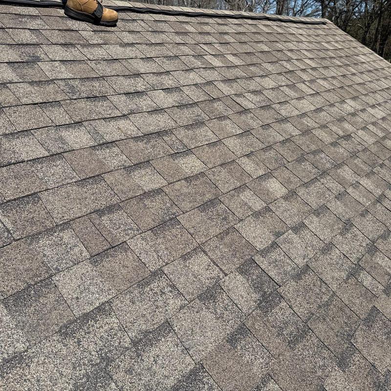 Asphalt shingle roof with visible hail damage inspection