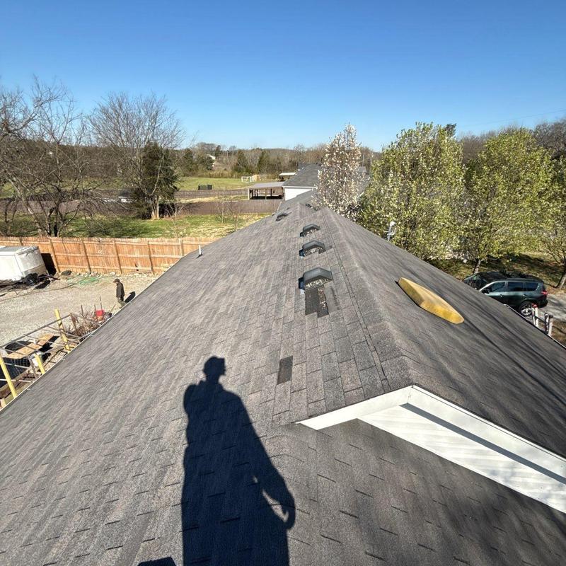 Asphalt shingle roof with ridge vents and hail damage