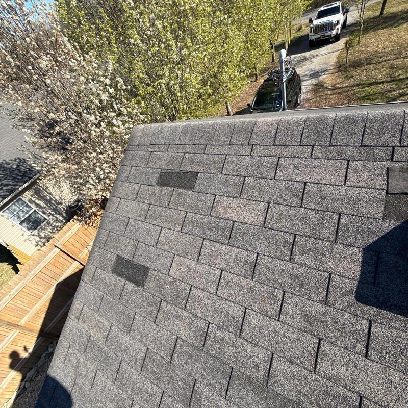 Asphalt shingle roof with hail damage patches