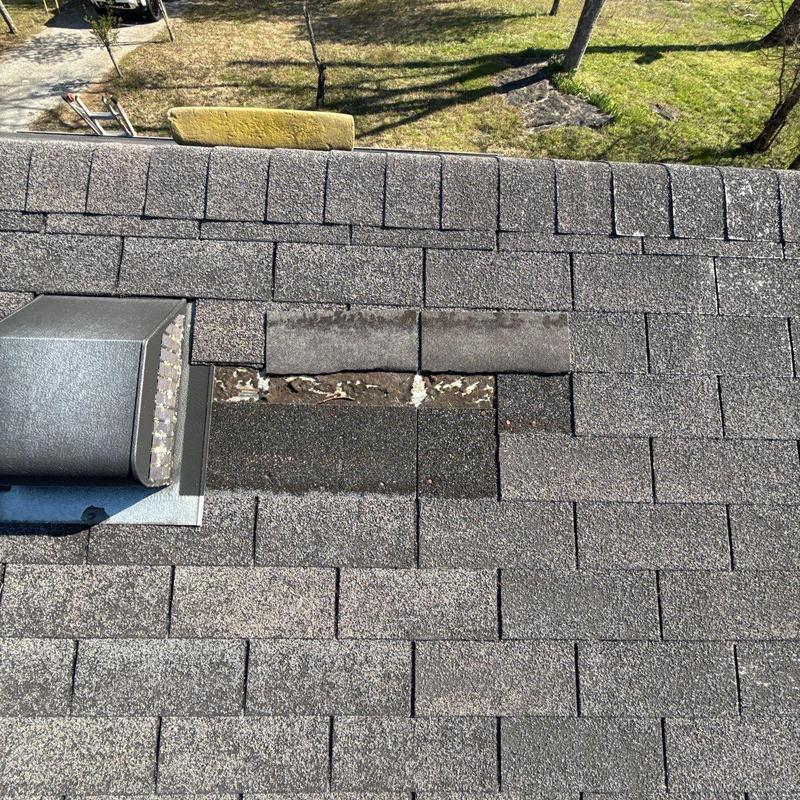Asphalt shingle roof with damaged missing shingles
