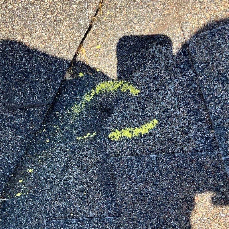 Asphalt shingles with marked hail damage on roof
