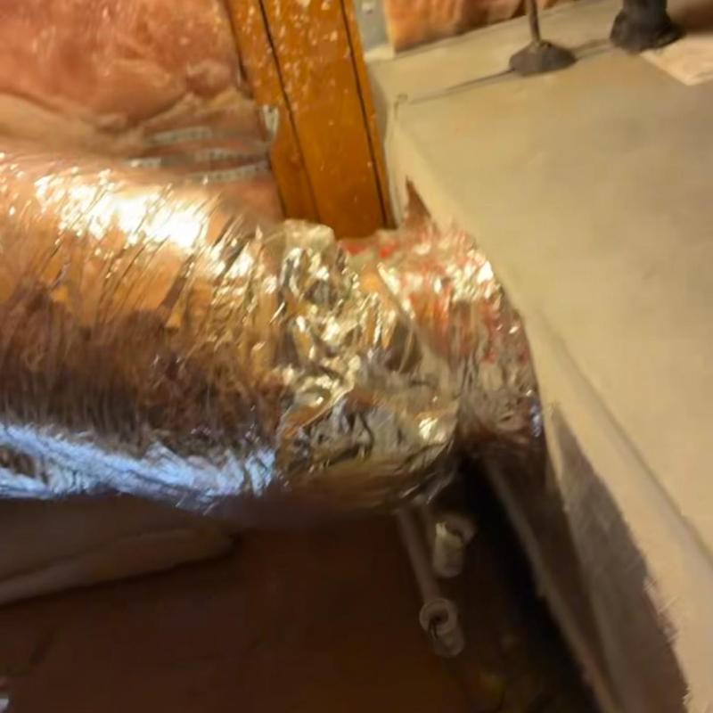 Flexible HVAC duct connection in basement crawlspace