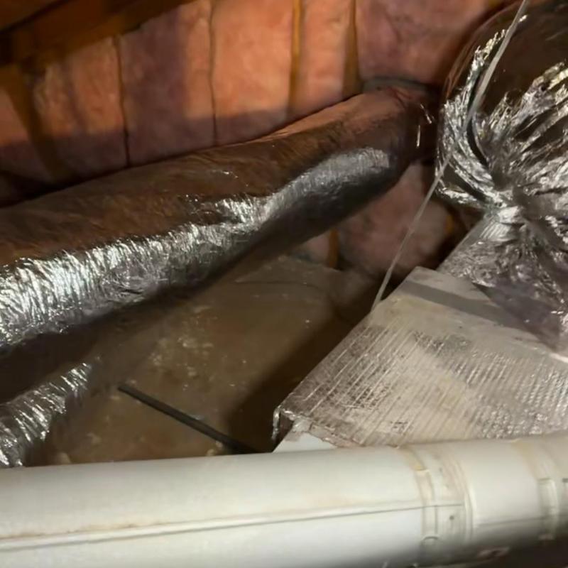 Insulated HVAC ductwork in attic with pipe nearby