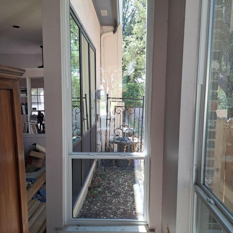 Vinyl window with bronze exterior and white interior frames