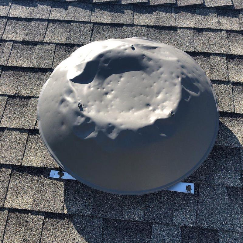 Metal roof vent damaged by hail on shingle roof