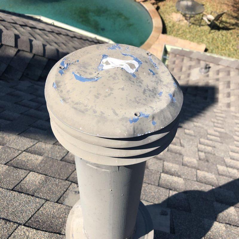 Roof vent cap with hail damage and chipped paint