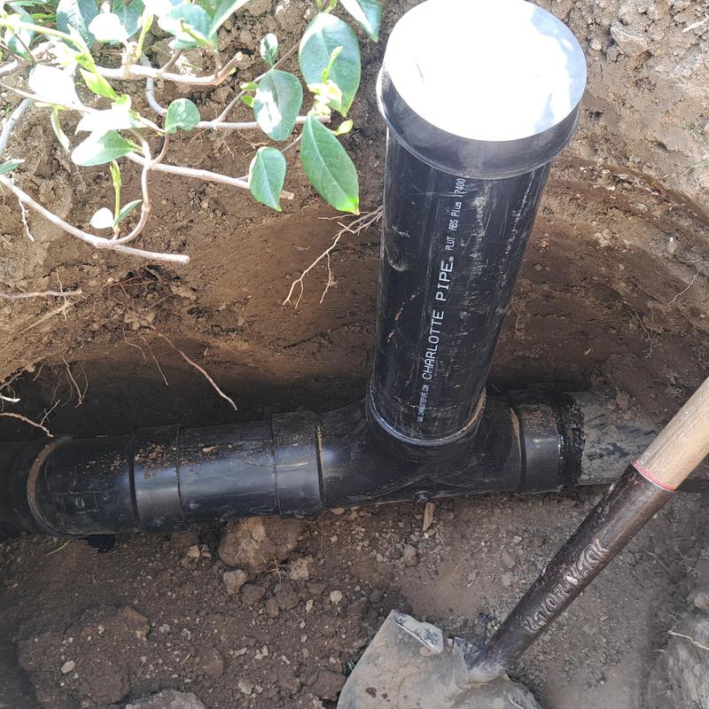 Sewer cleanout pipe installation in soil trench