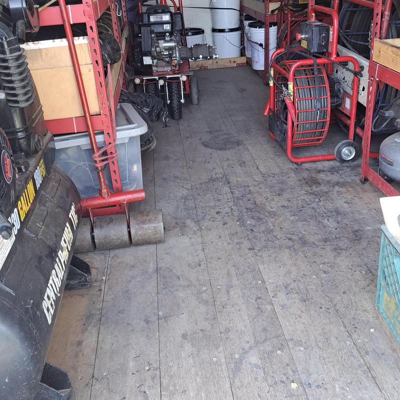 Sewer line cleaning equipment inside service truck