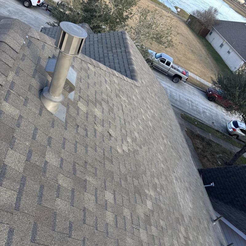 Asphalt shingle roof with metal vent installation