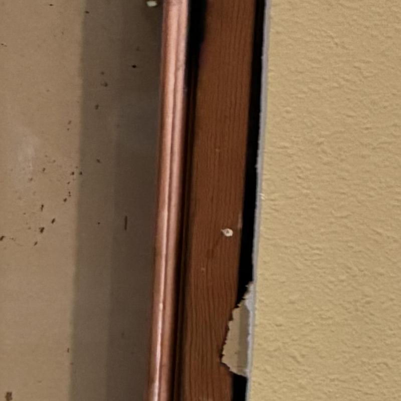 Three-quarter inch copper hot water line behind drywall