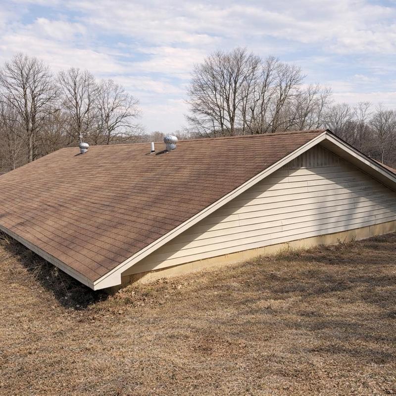 Asphalt shingle roof with vent fans and brown siding