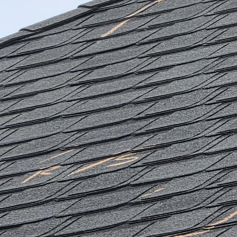 Asphalt shingle roof with hail damage marked for repair