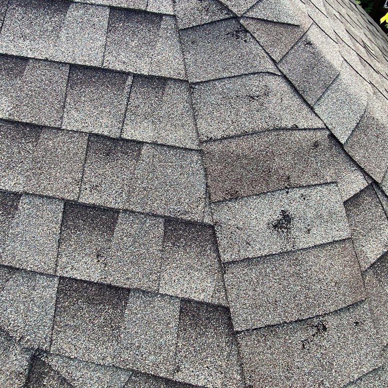 Asphalt shingle roof with visible hail damage marks