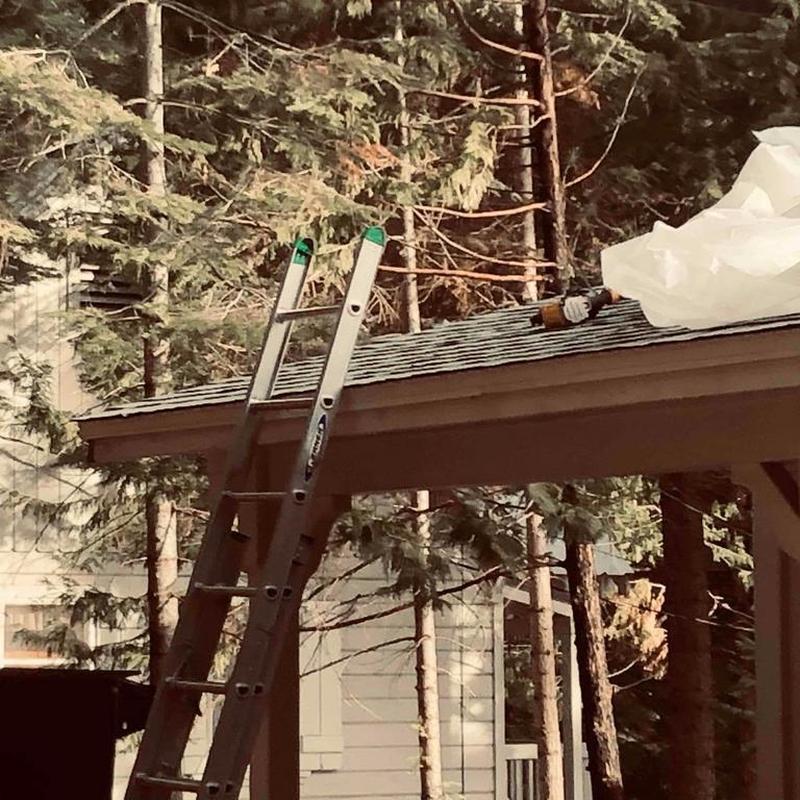 Asphalt shingle roof installation with ladder and tools