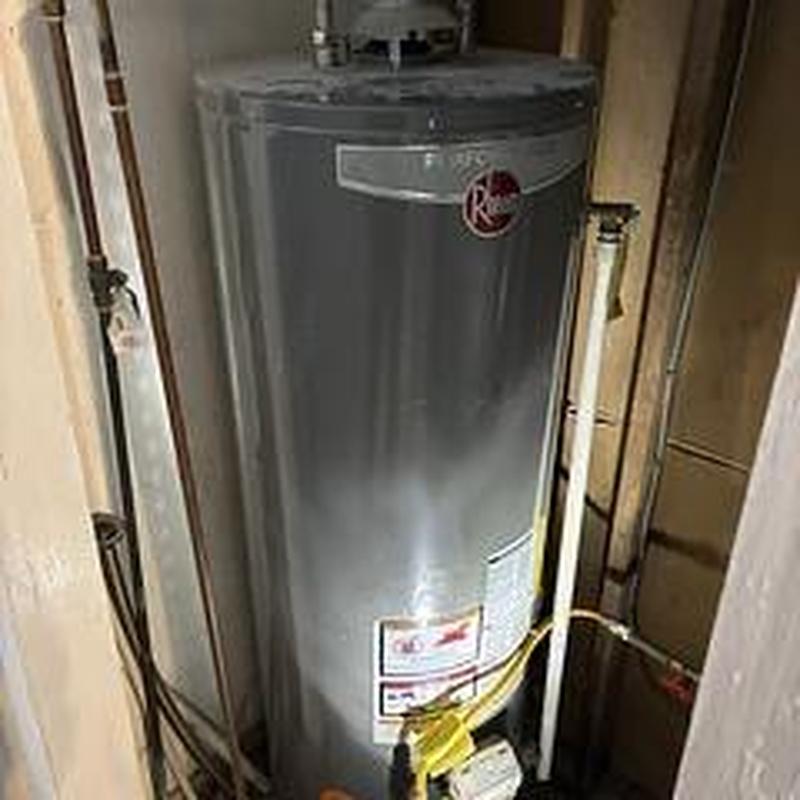 Water heater with pilot light and plumbing connections