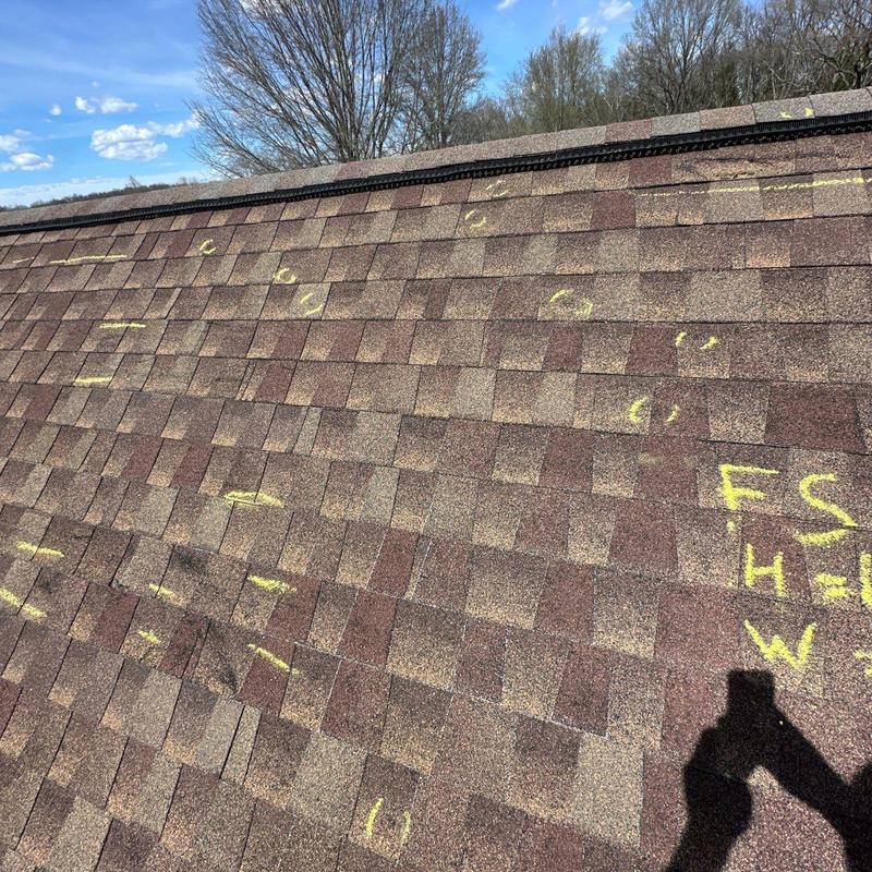 Asphalt shingle roof with hail damage markings