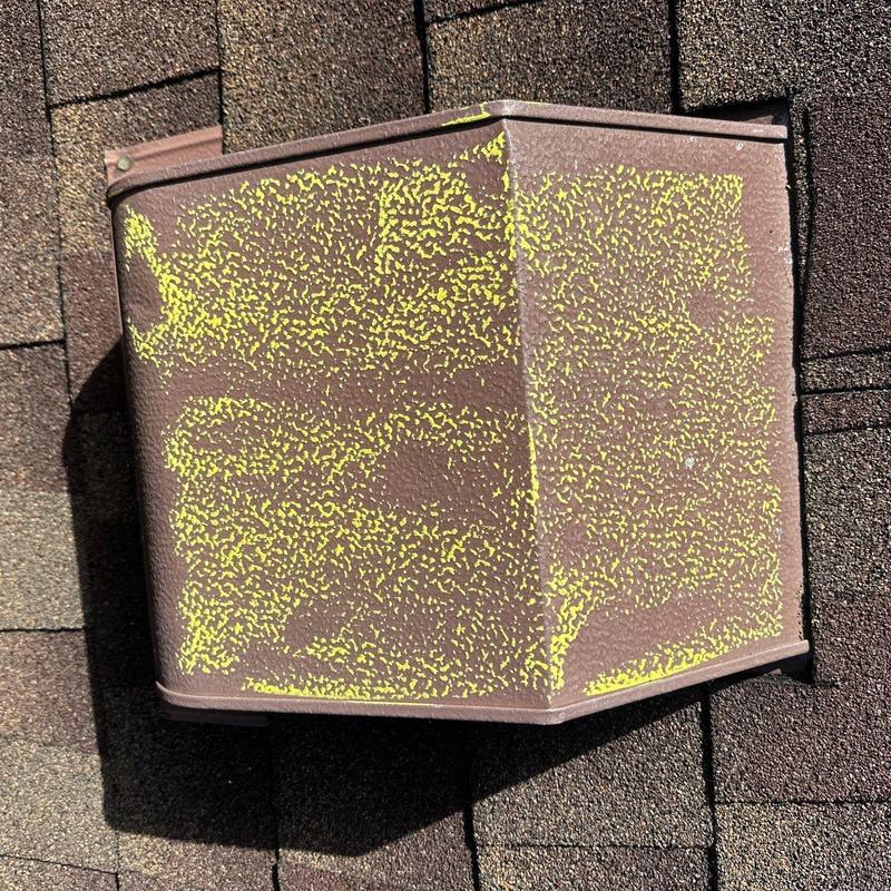 Metal roof ridge cap with hail damage markings