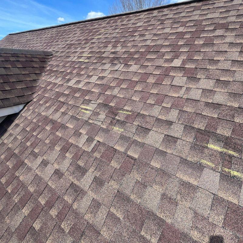 Asphalt shingle roof with marked hail damage areas