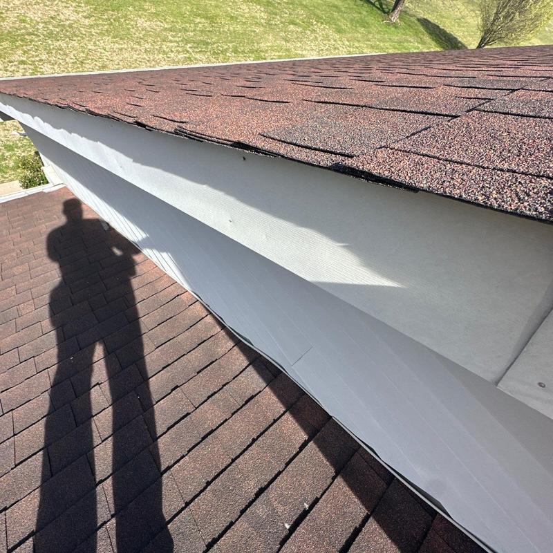 Asphalt shingle roof edge with minor hail damage