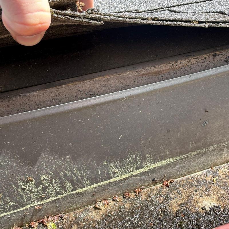 Roof flashing with hail damage under lifted shingles