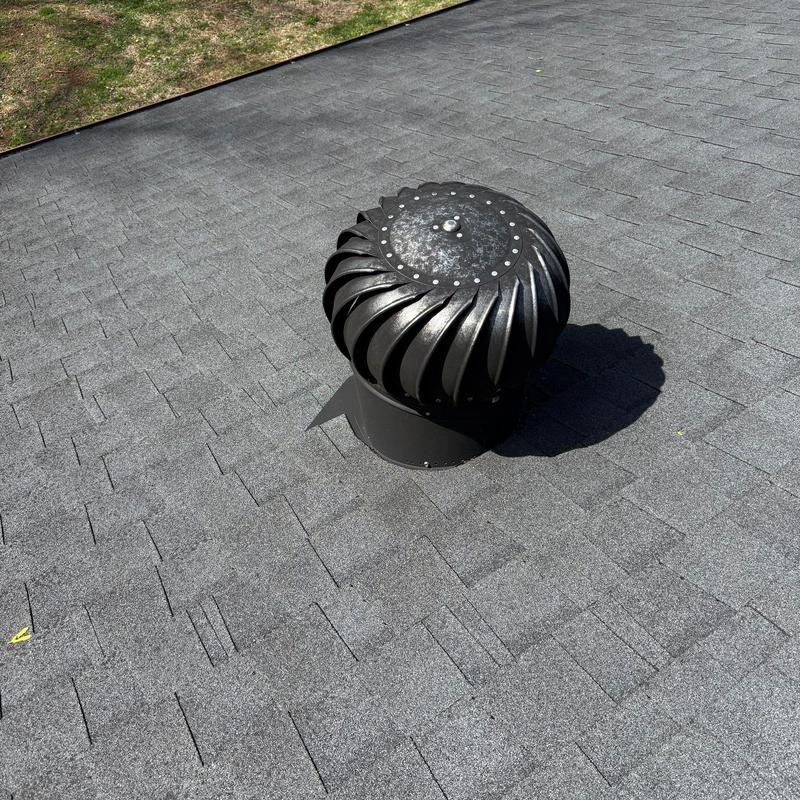 Roof exhaust vent on shingle roof with minor debris
